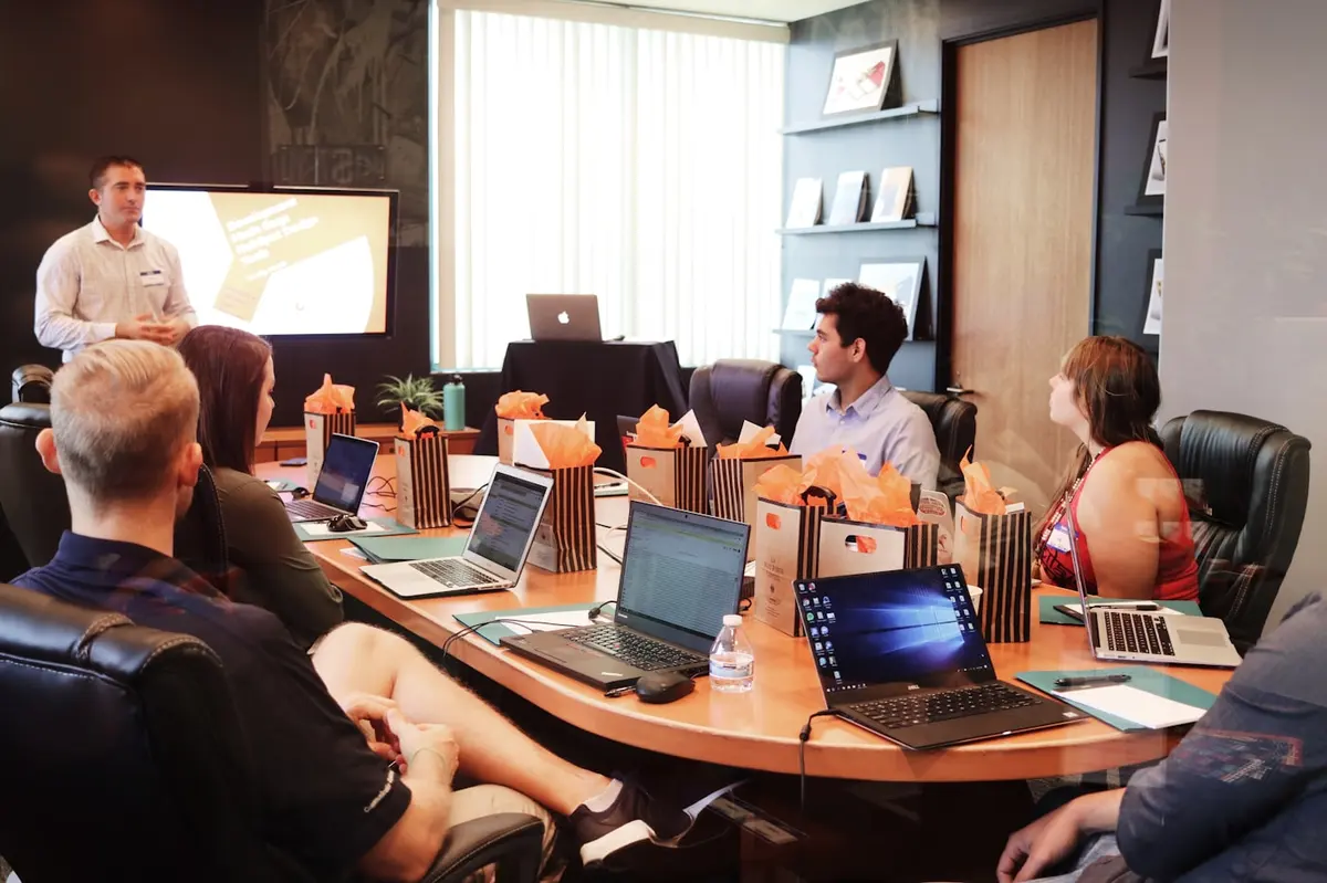 Overhead shot of laptops, phones and notes during a project review